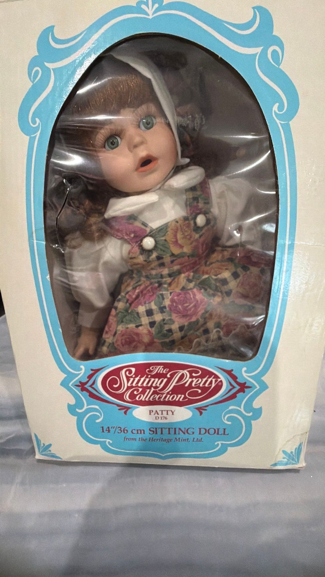 Sitting pretty porcelain doll